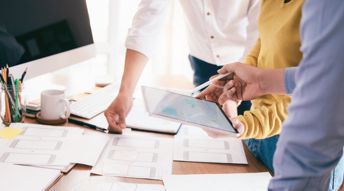 Three people at desk working