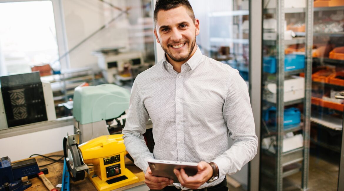 smiling guy holding a tablet