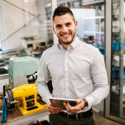 smiling guy holding a tablet