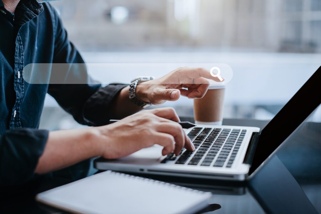 Google search bar and man working on SEO Blog Writing on laptop