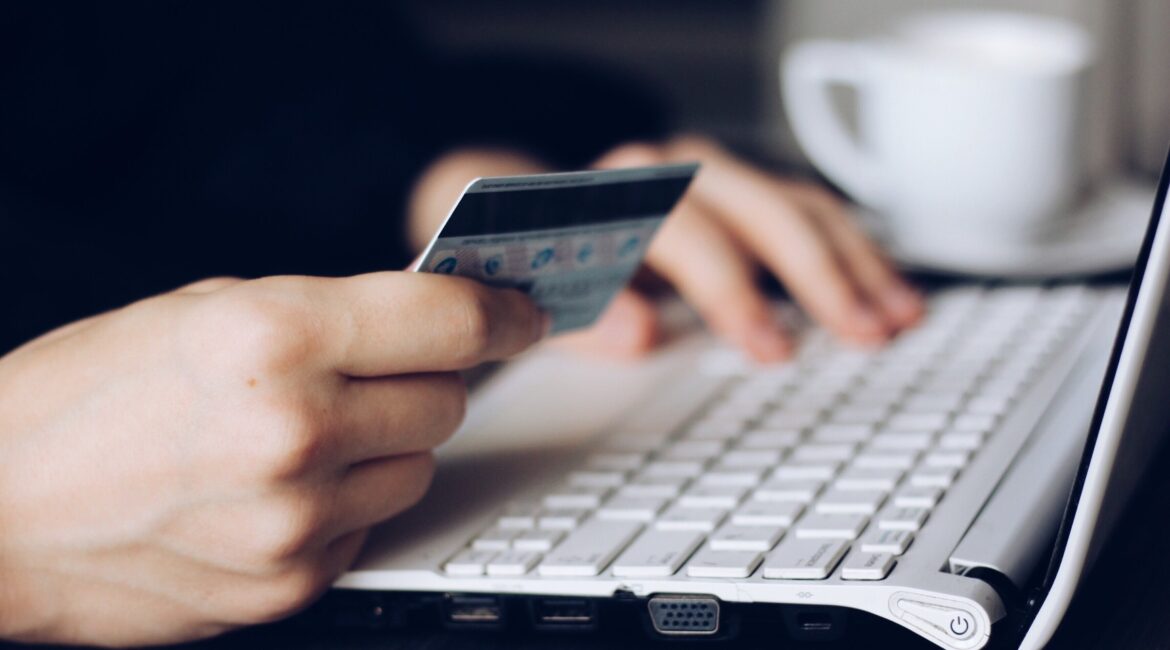 person using credit card to shop online