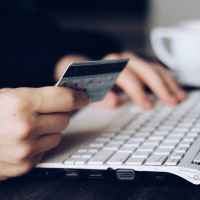 person using credit card to shop online