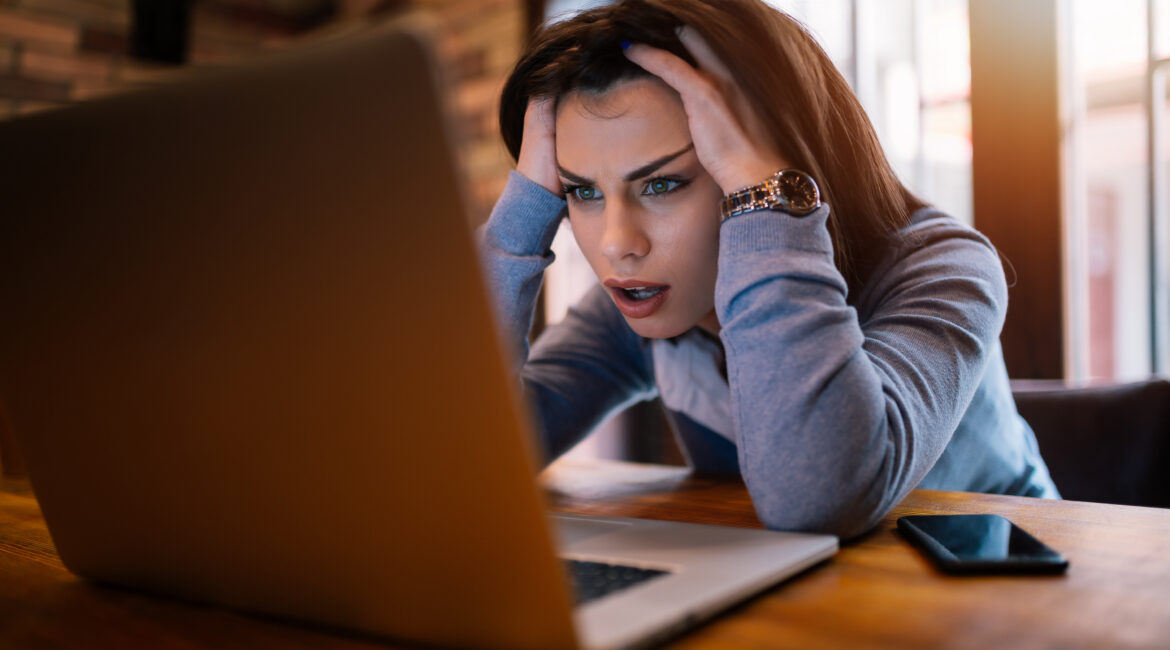 Woman frustrated that we computer is loading slowly