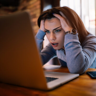 Woman frustrated that we computer is loading slowly