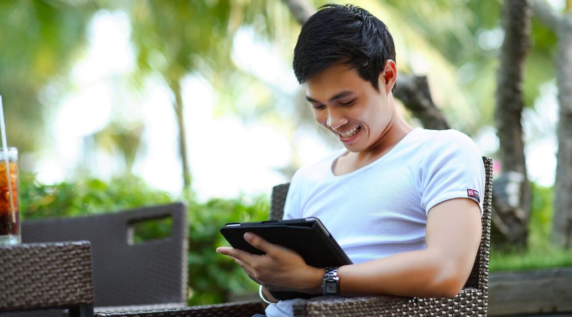 A man checking his business's Google Business Profile on a tablet